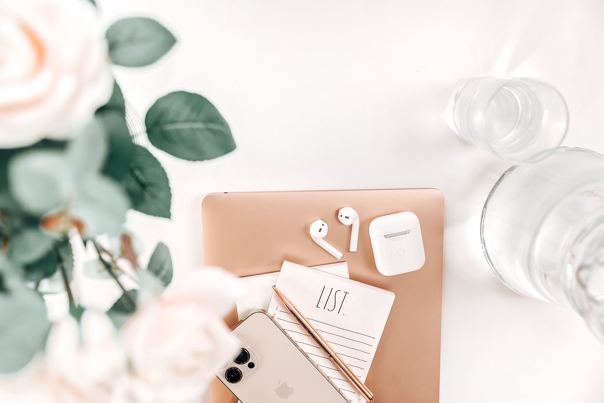 lowers-rosegold-laptop-iphone-todo-list-airpods-water. The brand of Hybrid Corner Shop